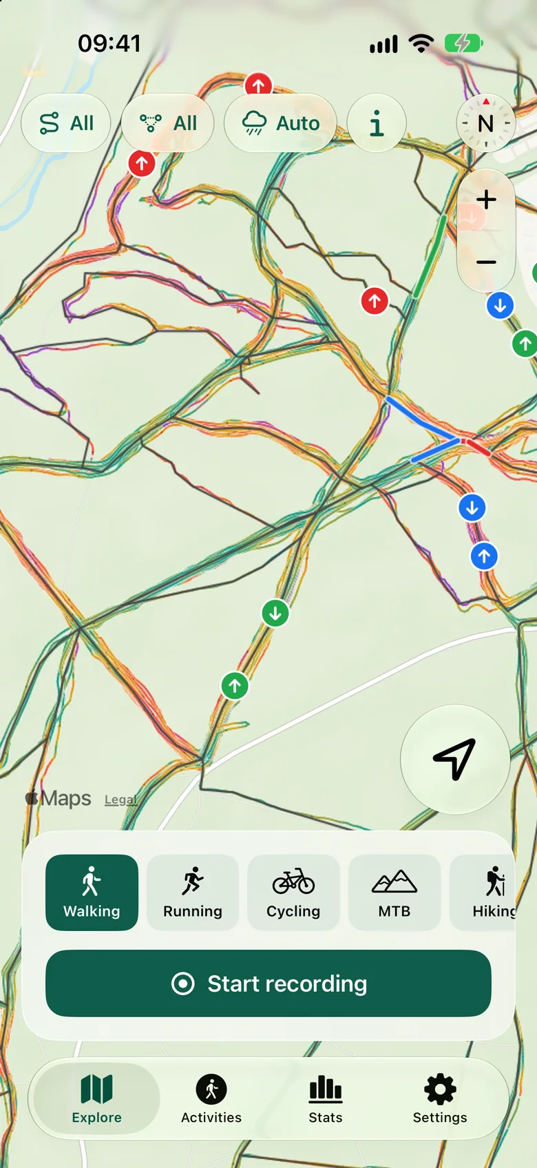 The Explore map in Cardio Trails: dozens of paths through a forest, each colored by slope, with green, blue and red difficulty badges.